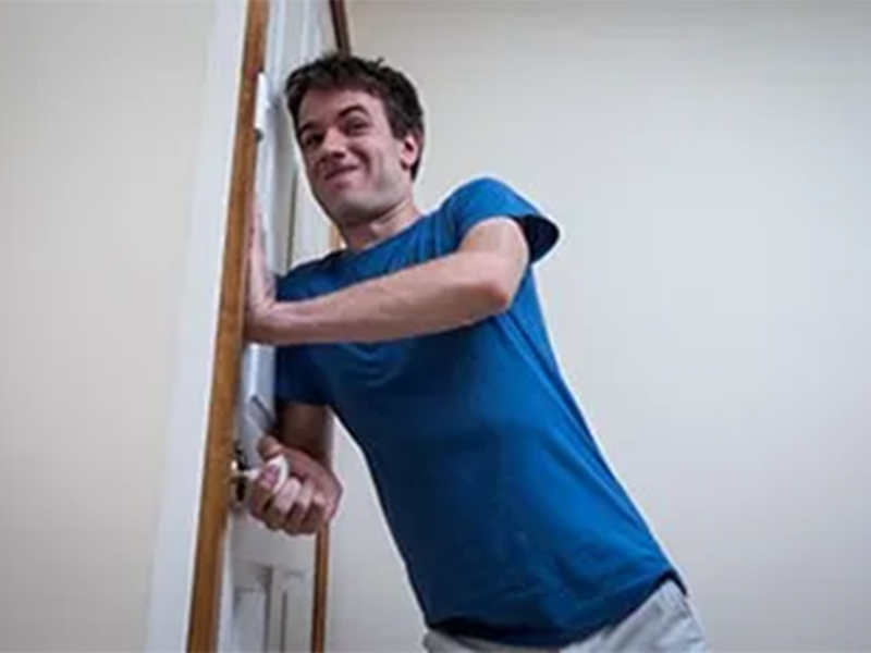 A man trying to open the door.