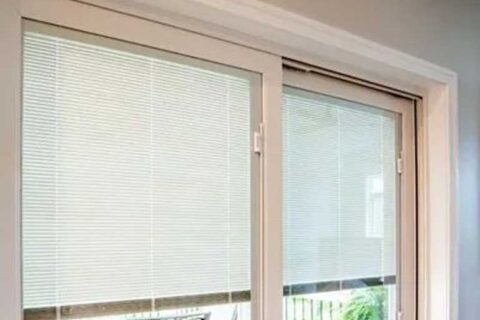 Sliding glass doors with built‑in blinds partially closed.