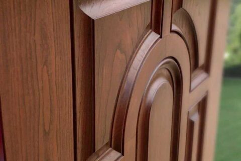 Close-up of a wooden door with detailed raised panel designs.