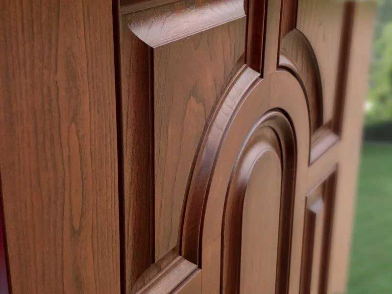 Close-up of a wooden door with detailed raised panel designs.