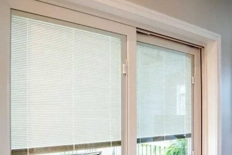 Sliding glass doors with built‑in blinds partially closed.