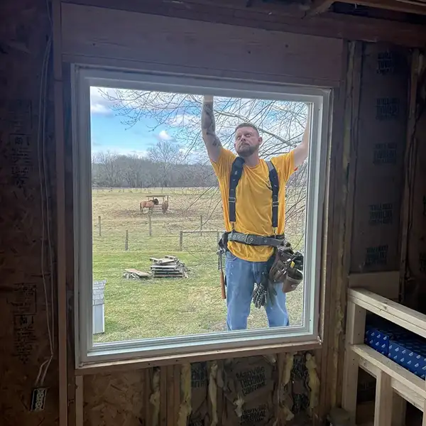 Peak Windows & Doors employee framing a window space