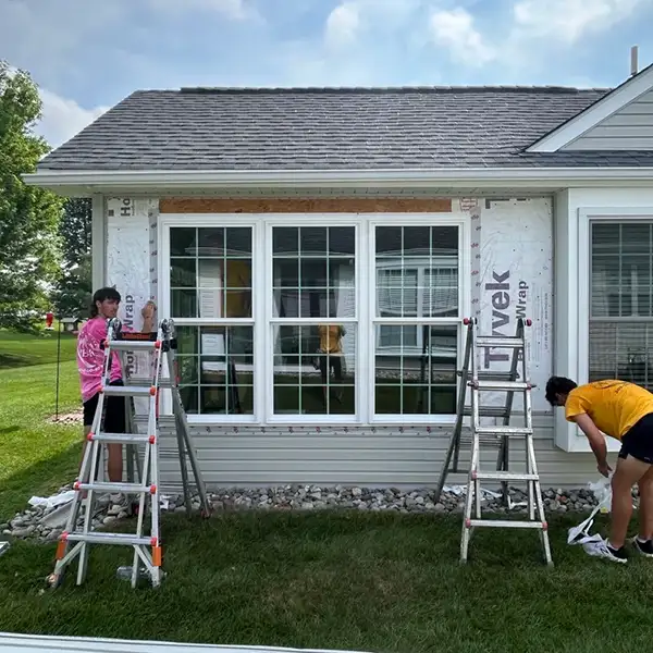installation of siding along new windows