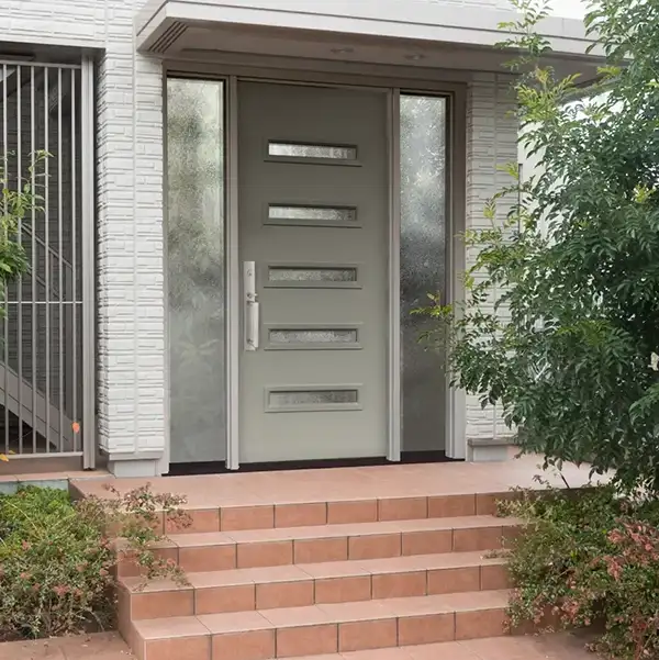 Modern gray front door with glass panels and tiled steps in New Castle County