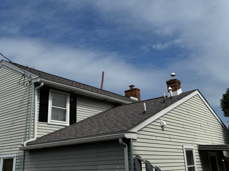 Gray Siding Home With Durable Asphalt Shingle Roofing in New Castle County, DE